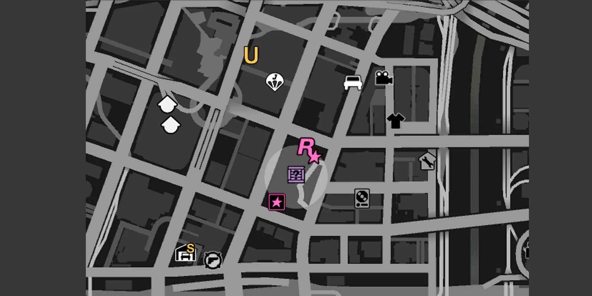 画像は、GTA Onlineマップ上のレギオンスクエアを示しており、グレーの円と紫のGのキャッシュの箱のアイコンが表示されています。