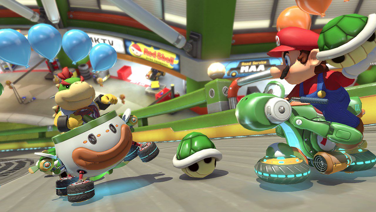 Mario che prende di mira un seme verde a Bowser Jr. in Mario Kart 8 Deluxe