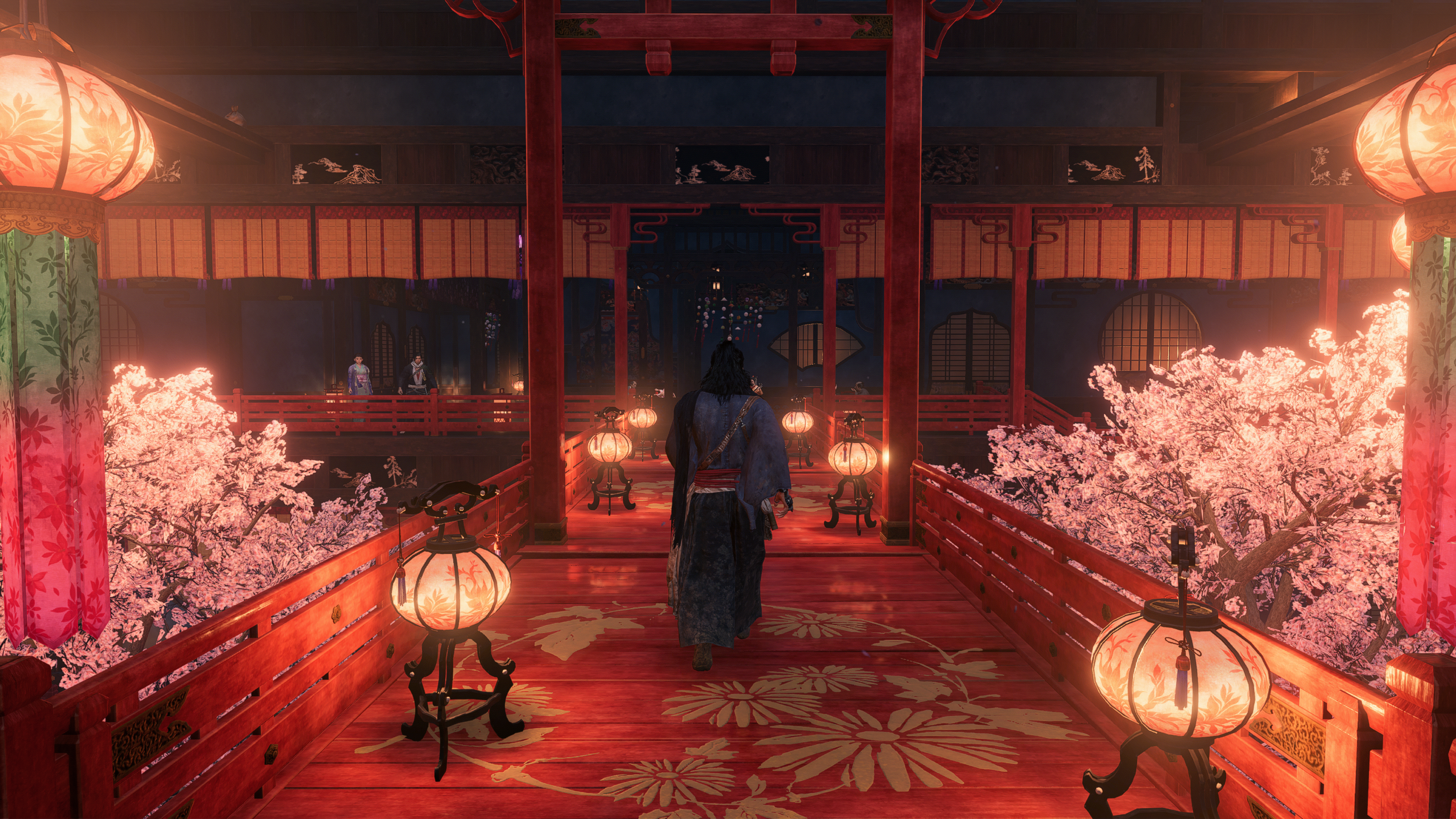 Capture d'écran officielle de Rise of the Ronin montrant le joueur marchant vers l'entrée d'un bâtiment traditionnel japonais rouge vif et rose
