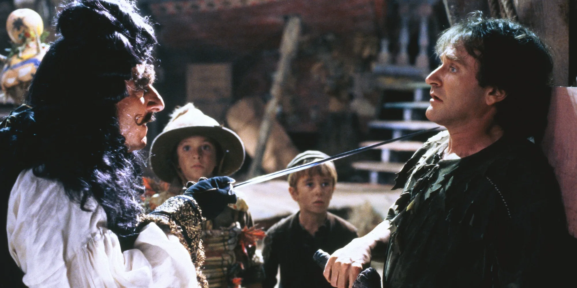 Hook and Peter Pan fight with children in the background
