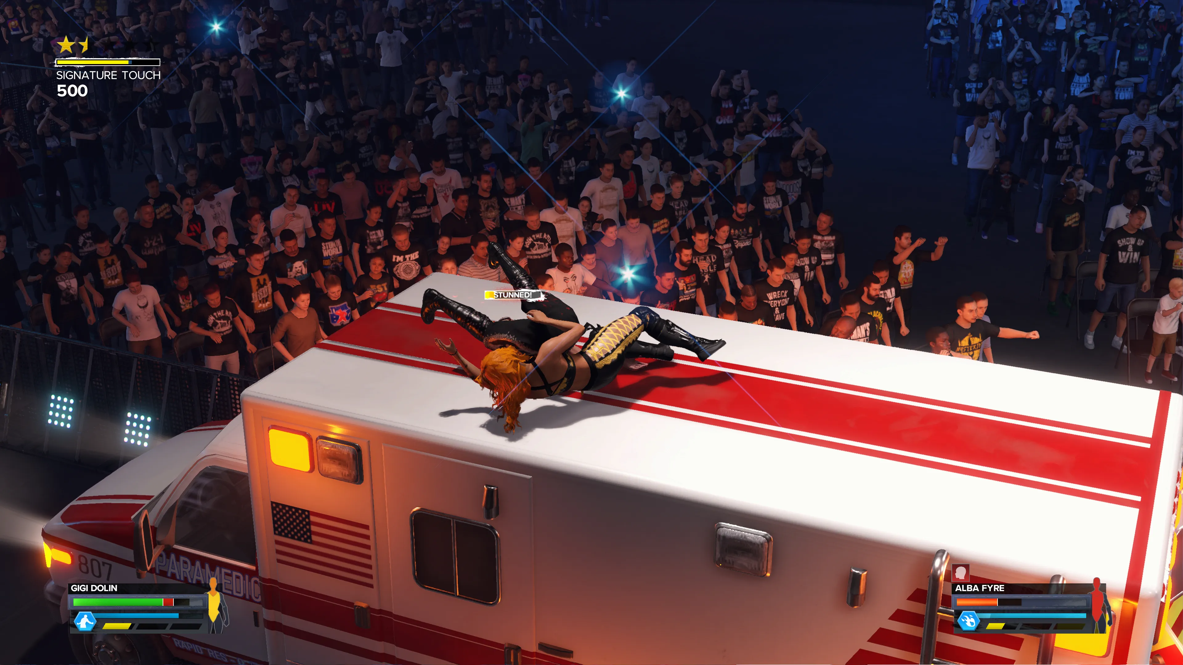 Gigi Dolin and Alba Fyre fight on the roof of an ambulance in an Ambulance Match in WWE 2K24.