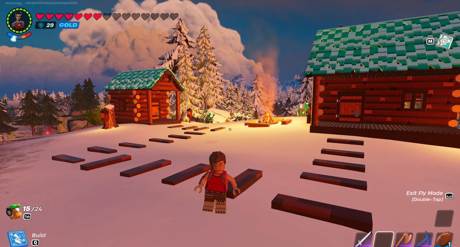 Giocatore di Lego Fortnite in Terre Ghiacciate accanto a due capanne di tronchi