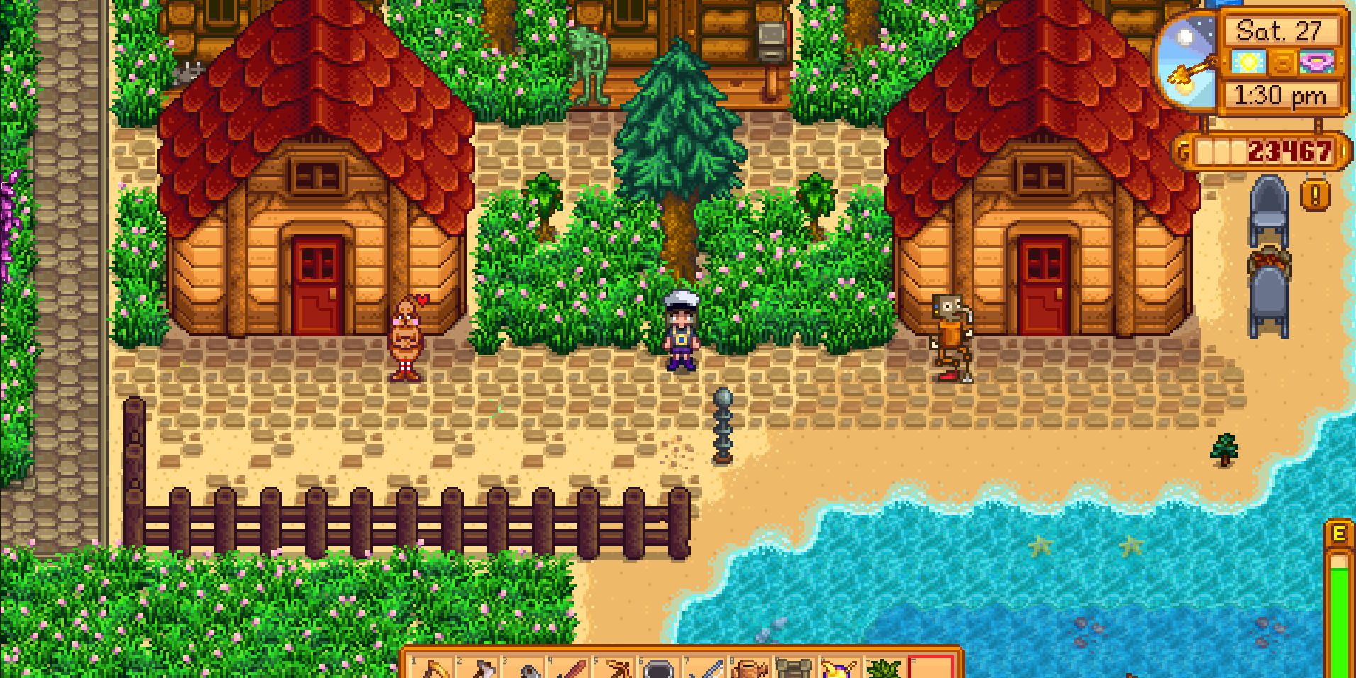 Image of a character standing between two buildings with some secret statues in Stardew Valley