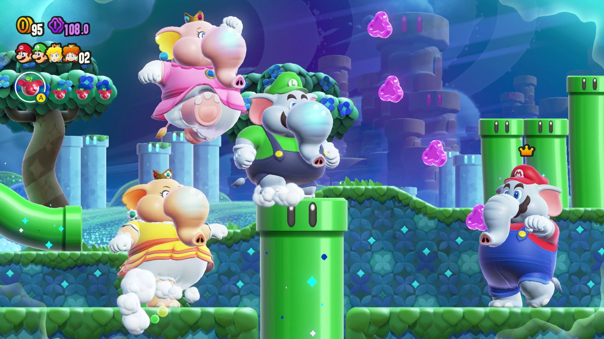 Daisy, Peach, Luigi e Mario, sotto forma di elefante, corrono attraverso un livello pieno di tubi in Super Mario Bros. Wonder