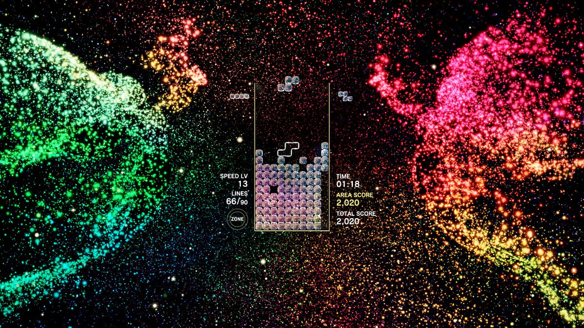 Due creature angeliche a base di particelle ballano sul lato di un livello di Tetris Effect.