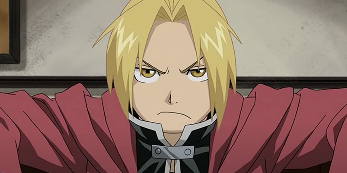 Edward Elric from the anime of Fullmetal Alchemist giving an annoyed expression in a red coat