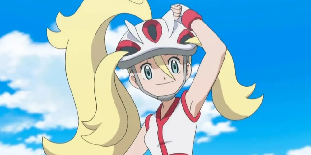 Anime Pokemon Korrina souriant et ajustant son casque