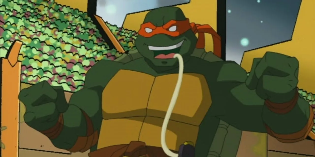 주황색 마스크를 한 거북이가 입에 튜브와 같은 것을 가지고 있는 이미지입니다.