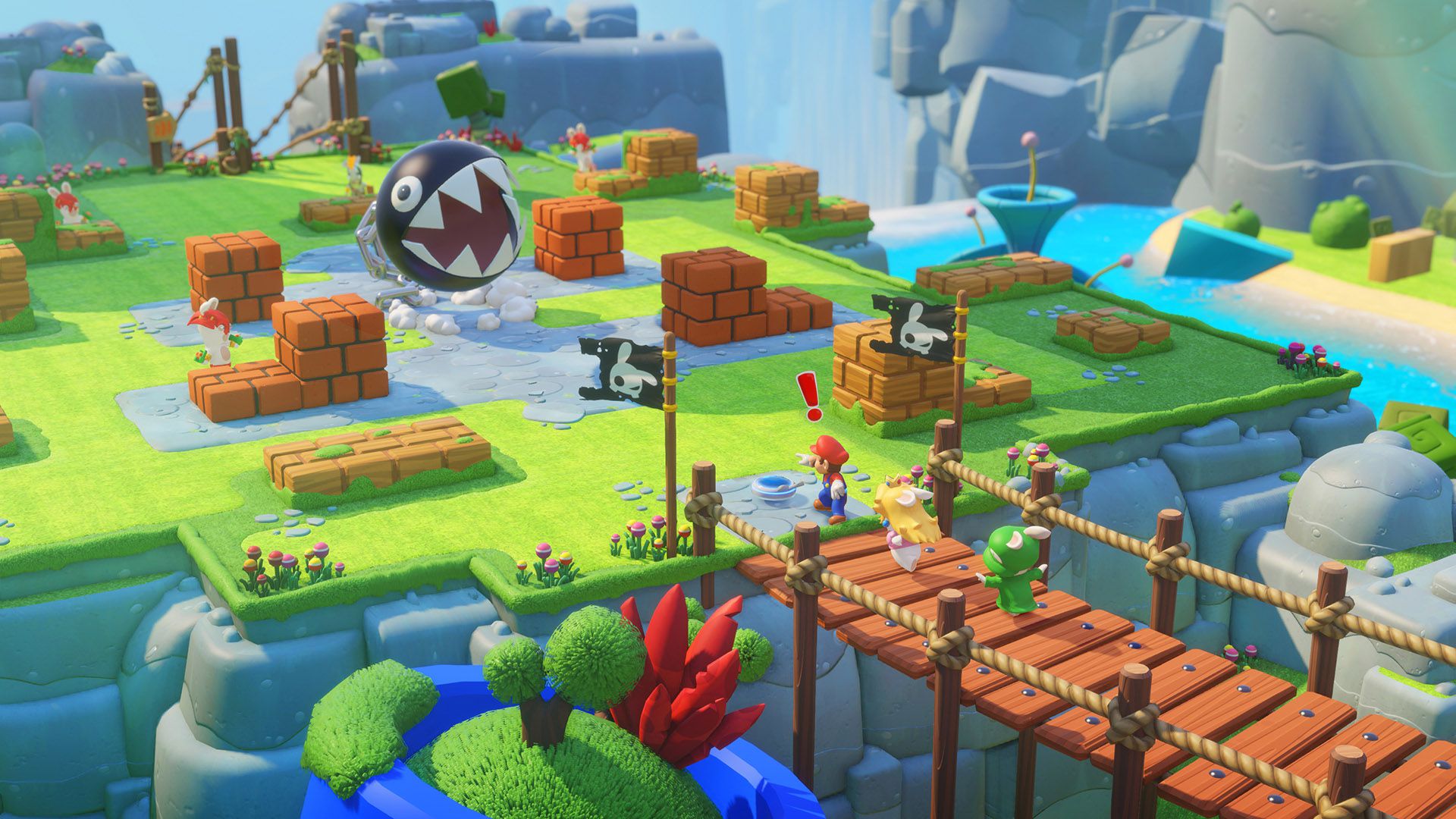 Cette capture d'écran de Mario + Rabbids Kingdom Battle montre Mario se tenant devant deux lapins traversant un pont. L'un des lapins est déguisé en Princesse Peach et l'autre en Luigi. Mario a un point d'exclamation au-dessus de sa tête et est