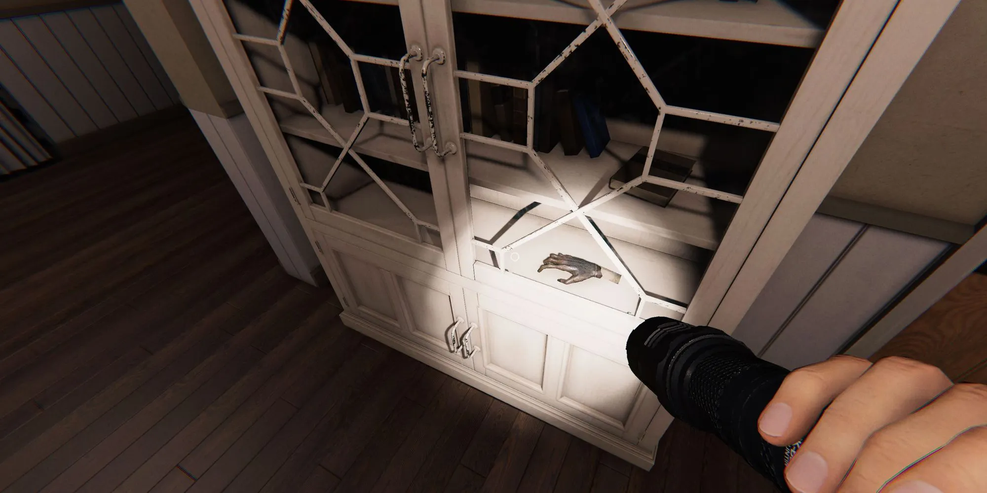 Image depicts the monkey paw in a cabinet in the hallway of Willow Street in Phasmophobia.