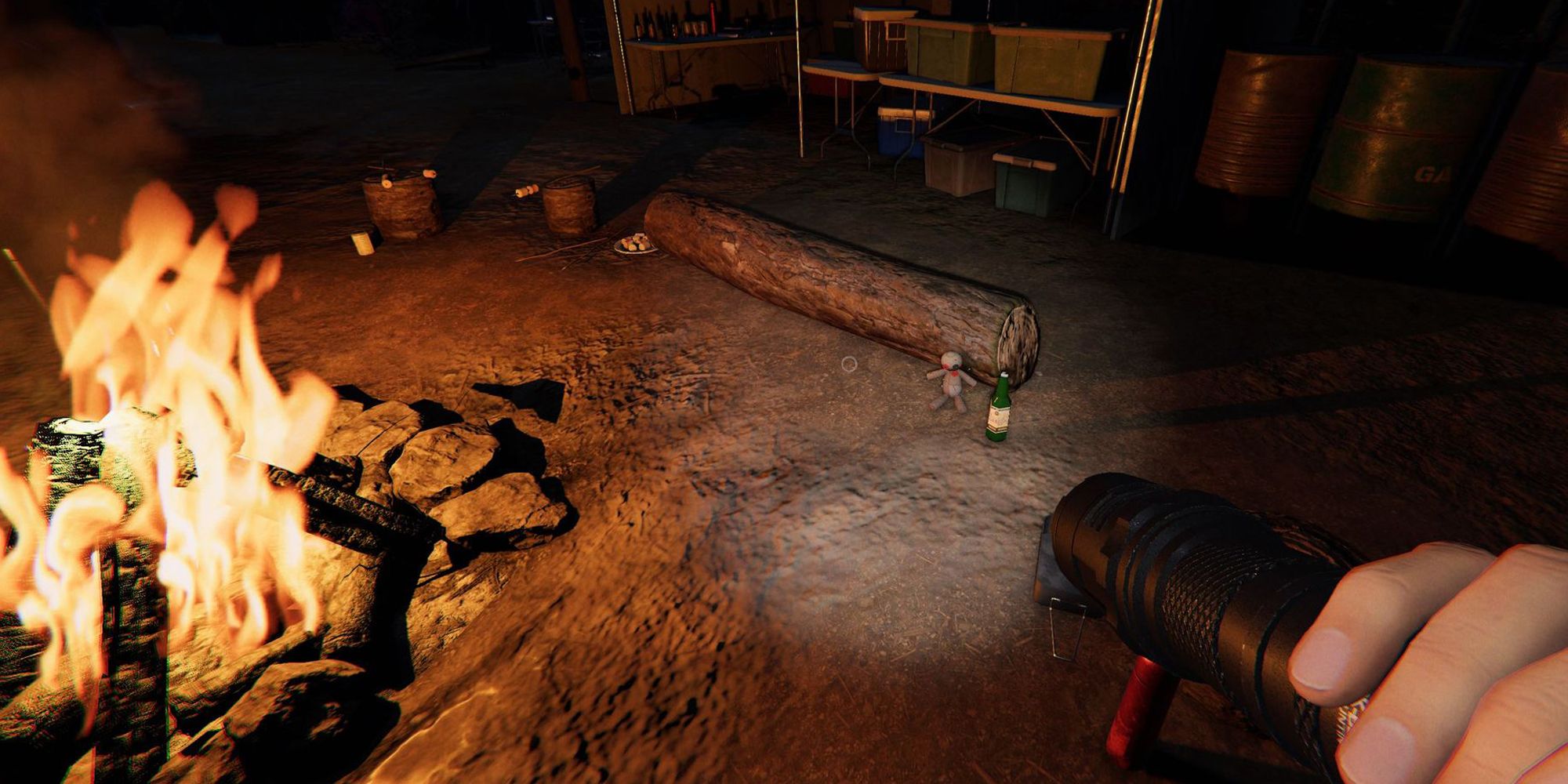 Image depicts a voodoo doll next to a log and green bottle sat near a campfire in Maple Lodge Campsite in Phasmophobia.
