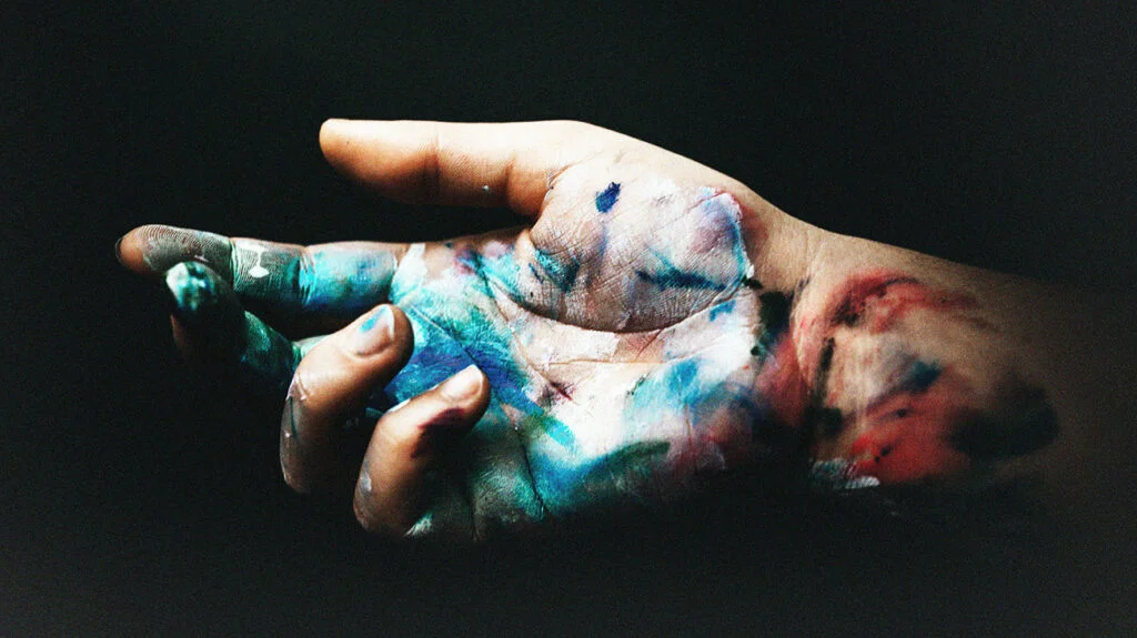 Una mano con schizzi di vernice