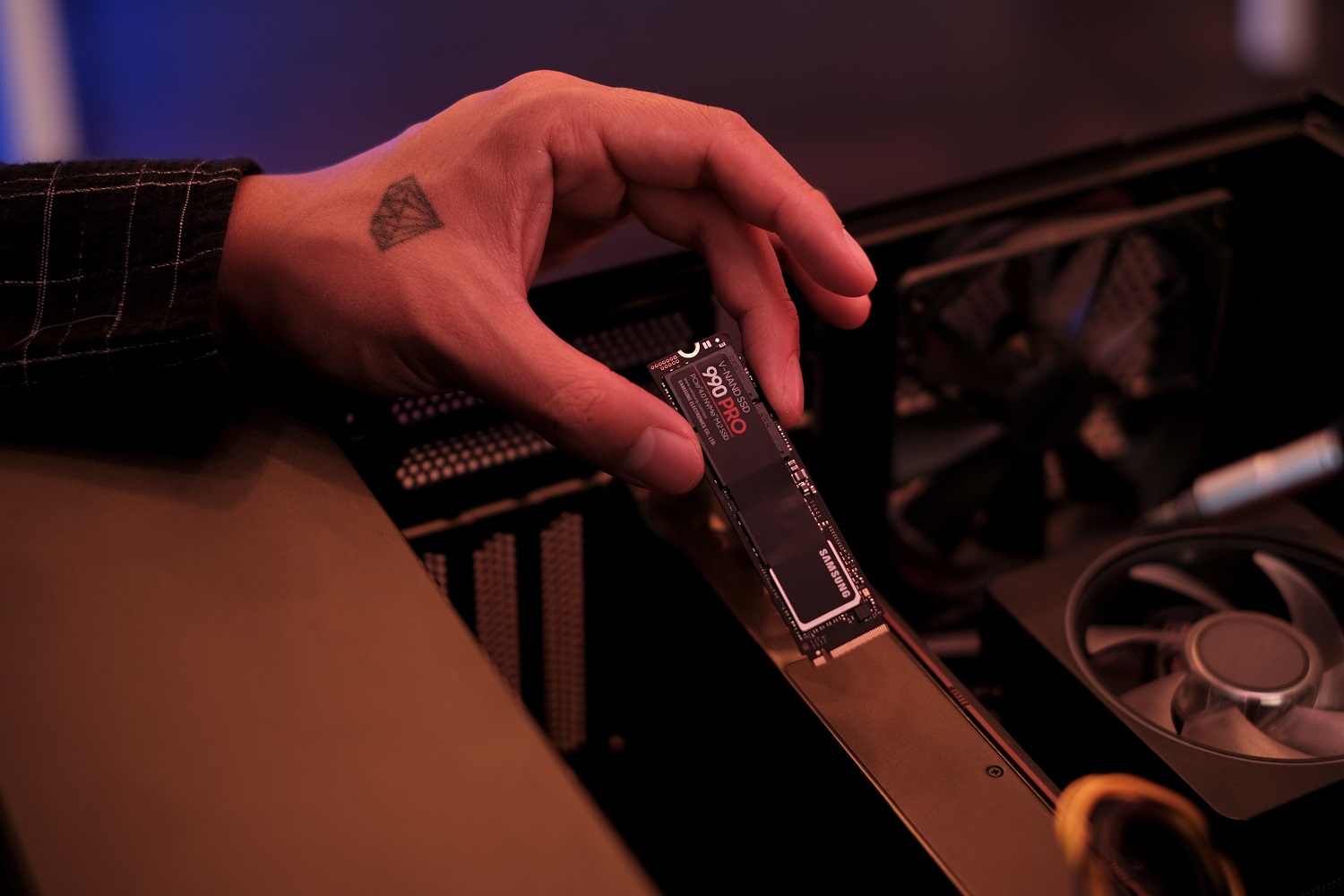 The Samsung 990 Pro SSD being installed in a PC