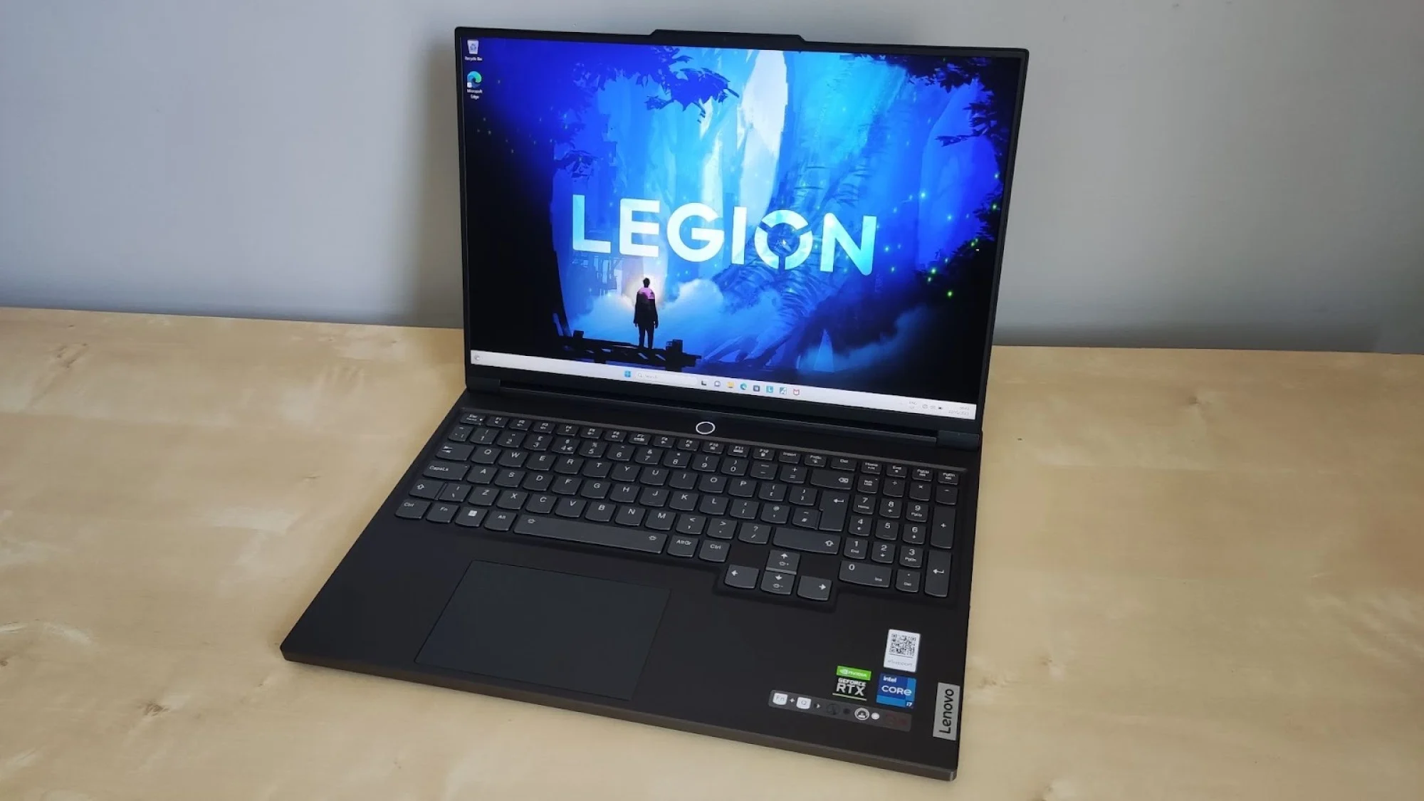 the Lenovo Legion Slim 7i gaming laptop on a desk with open screen