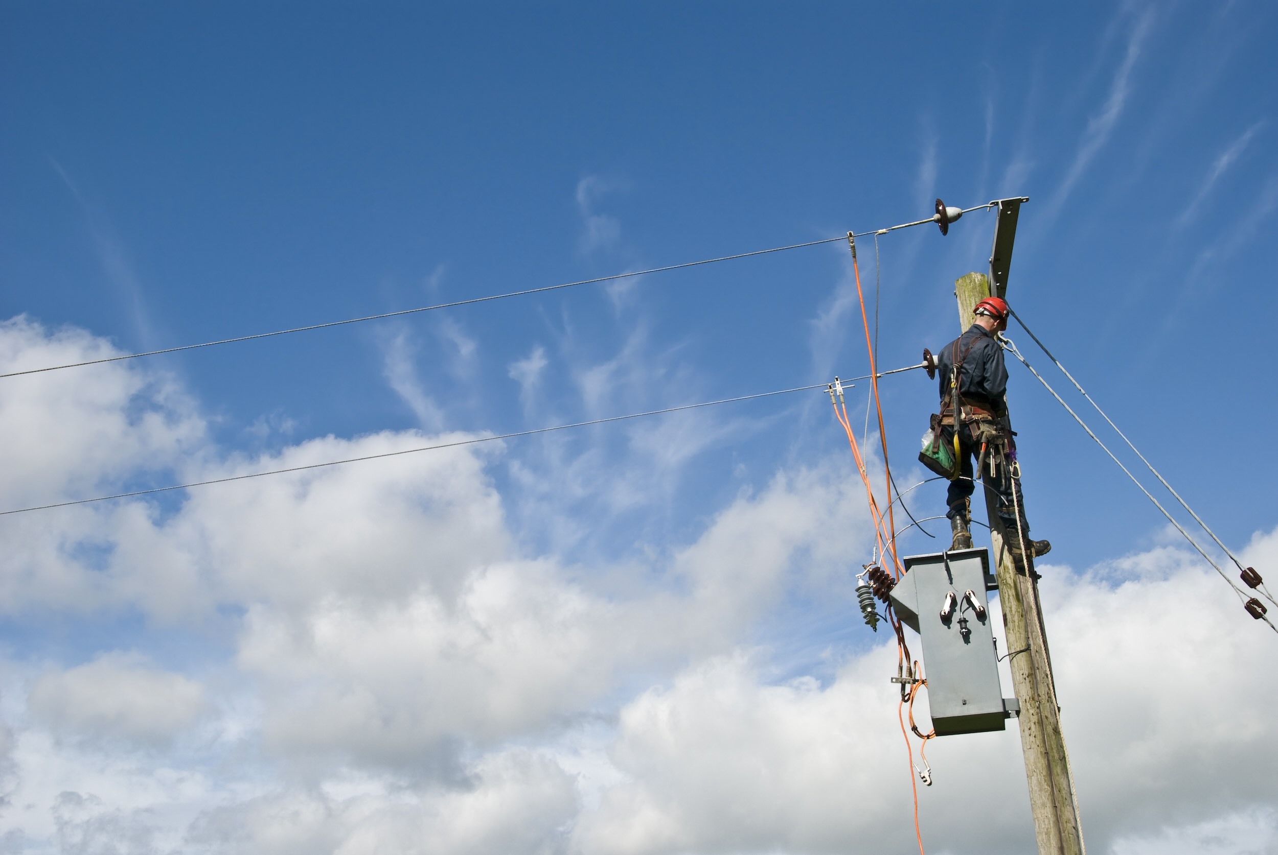 Utility worker repairing power lines