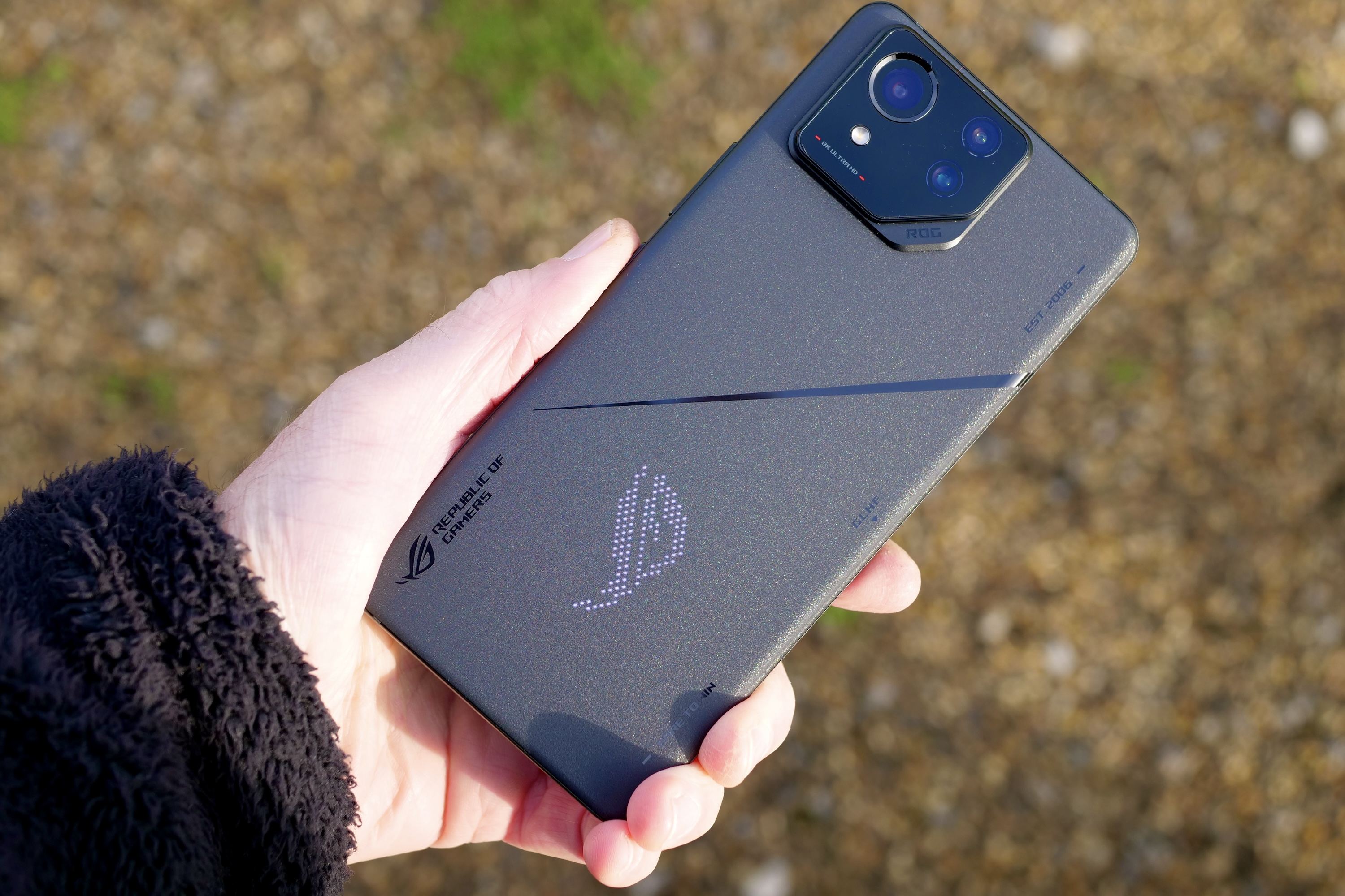 A person holding the Asus ROG Phone 8 Pro