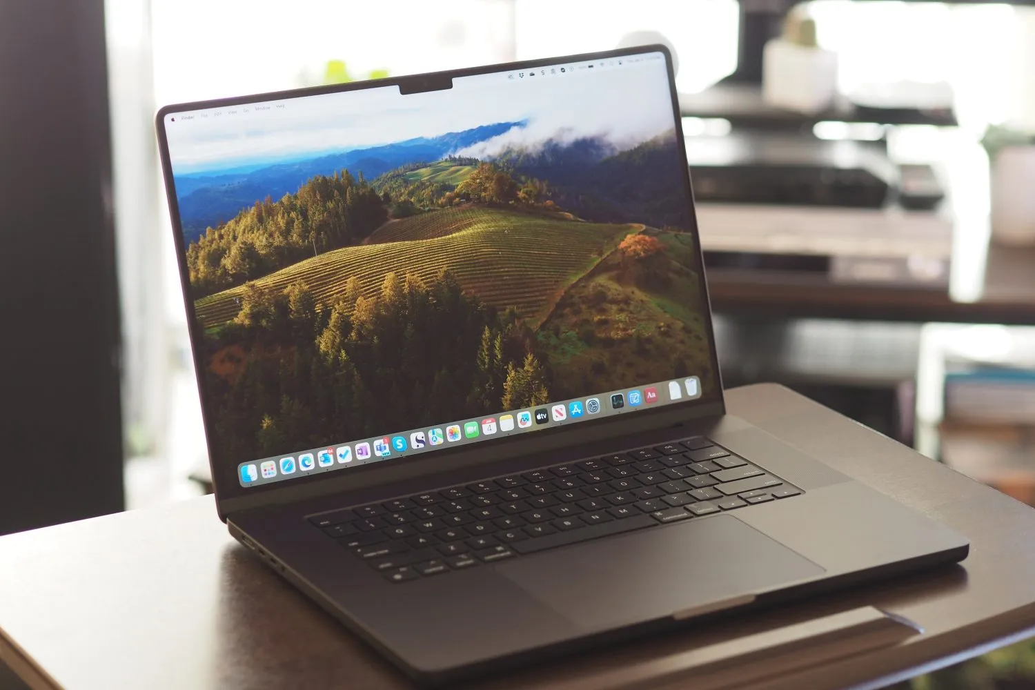 Apple MacBook Pro 16 vista frontal e inclinada mostrando display e teclado